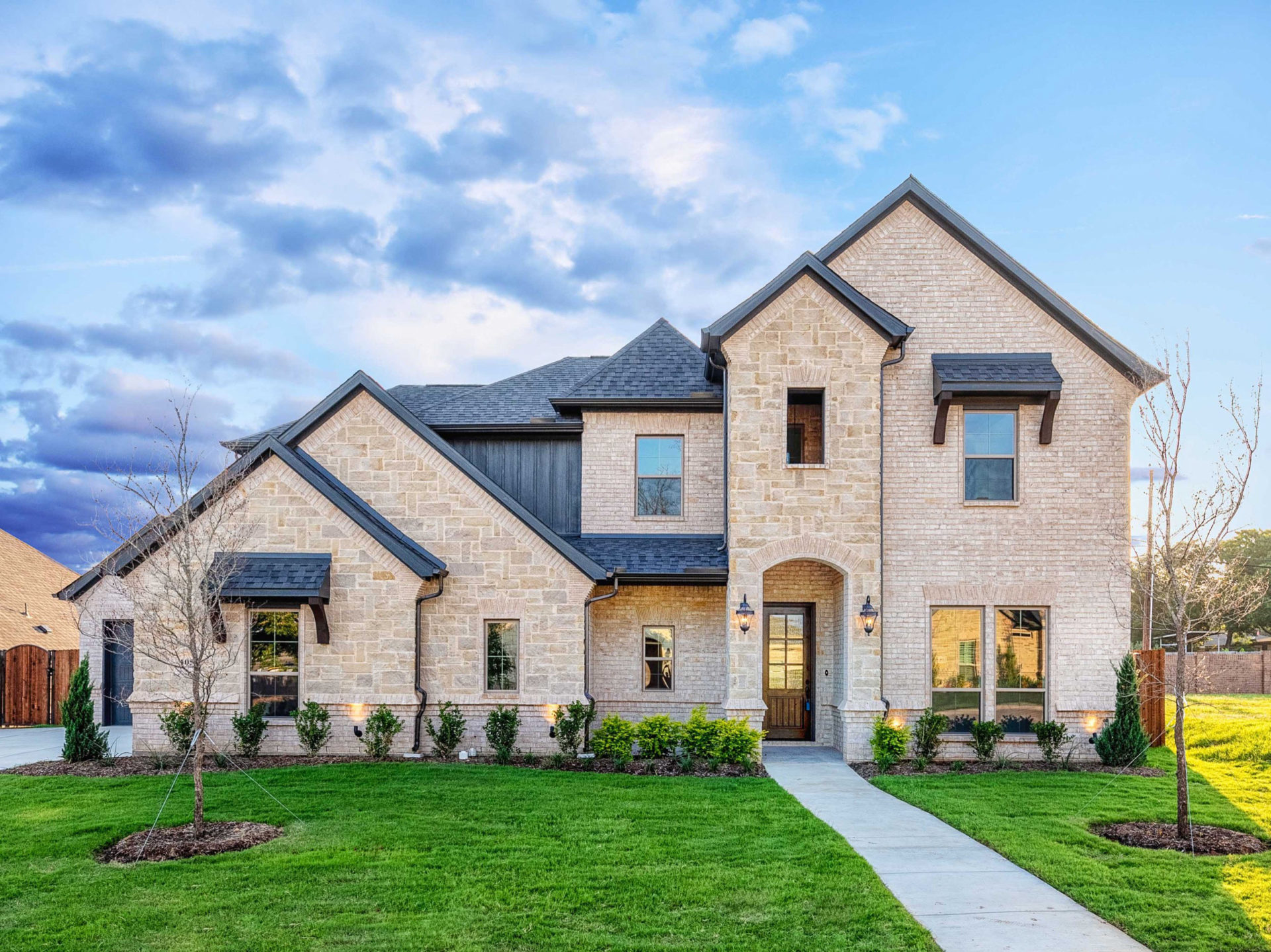 Front elevation of a stone-and-brick custom home, Ashlyn project